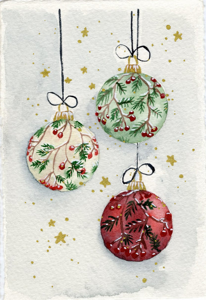 Carte de Noël à l'aquarelle : trois boules décorées de branches et de baies